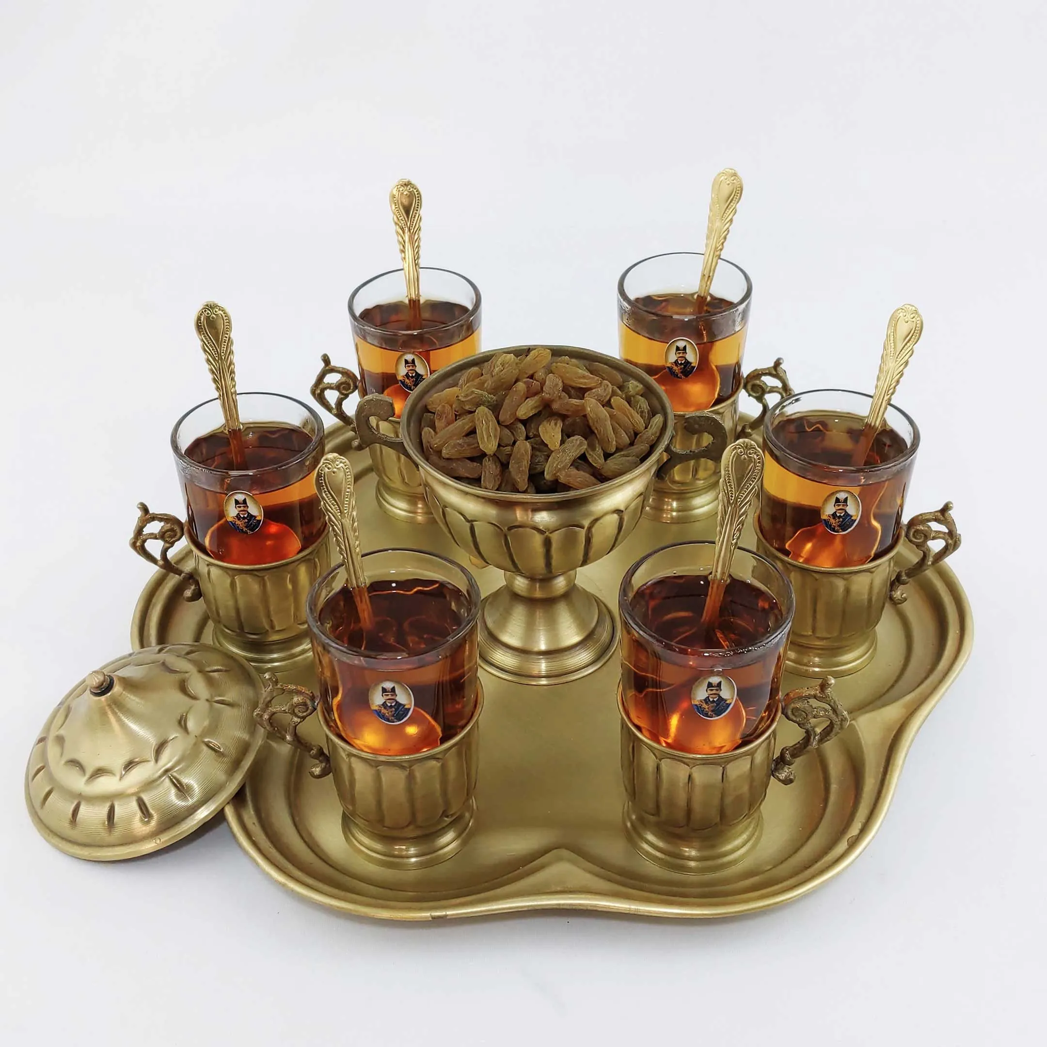 Elegant tea service set with teapot, cups, and saucers on a decorative tray.