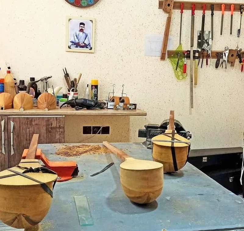 Craftsman making a traditional Persian Setar instrument from mulberry wood