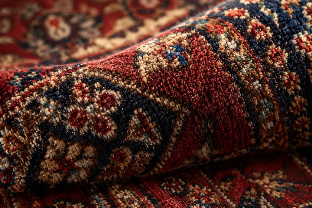 Close-up of the pile and knots of a hand-knotted Persian rug showing fine wool detail